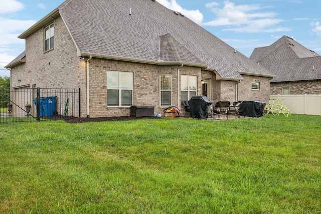 back of property featuring a patio area and a yard