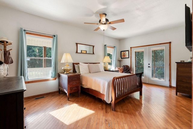 bedroom featuring access to exterior, french doors, light hardwood / wood-style floors, and ceiling fan