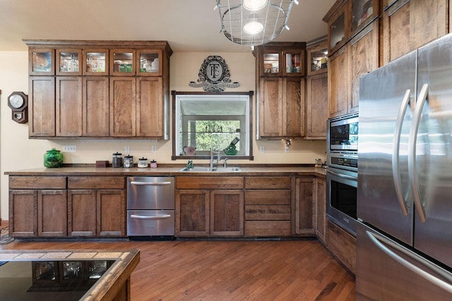 kitchen featuring appliances with stainless steel finishes, dark hardwood / wood-style flooring, and sink