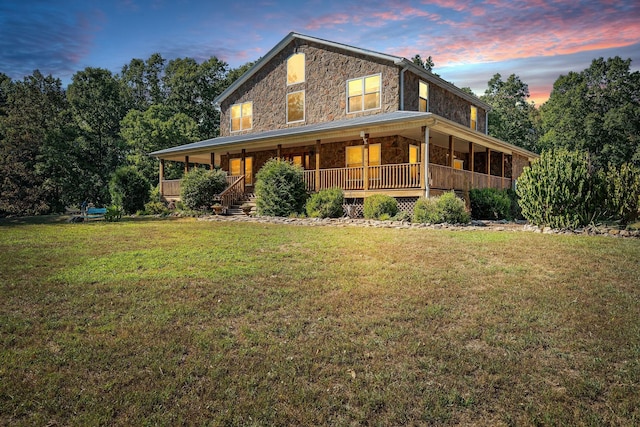 exterior space featuring a lawn and covered porch