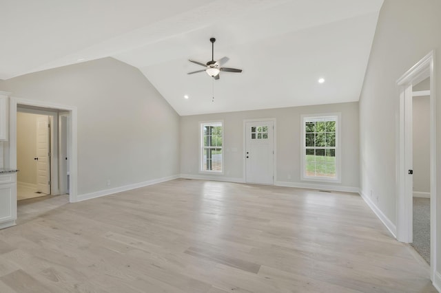 unfurnished living room featuring ceiling fan, light hardwood / wood-style flooring, and vaulted ceiling