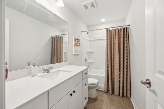 full bathroom with shower / bath combination with curtain, vanity, and toilet