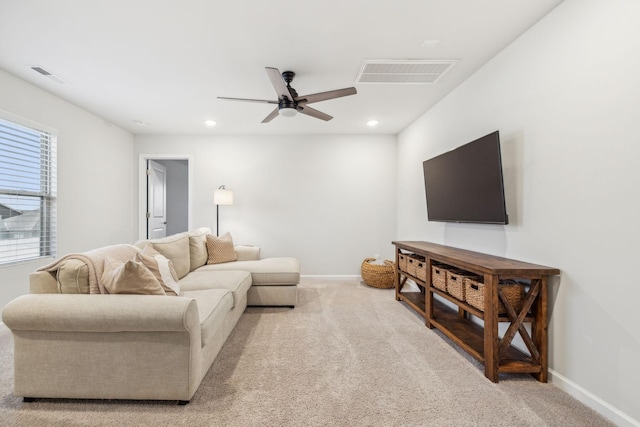 living room with light colored carpet and ceiling fan