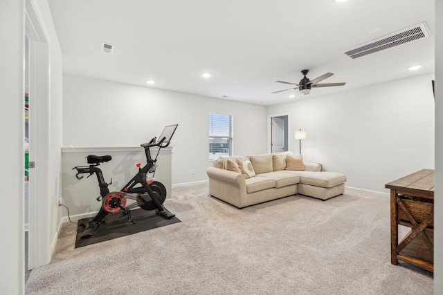 workout room featuring light carpet and ceiling fan