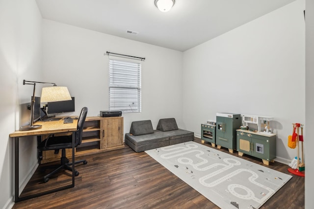 home office with dark hardwood / wood-style floors