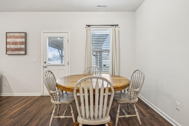 dining space featuring dark hardwood / wood-style flooring