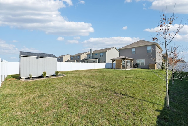 view of yard with a gazebo and a storage shed