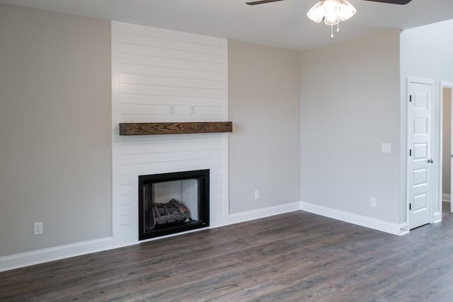 unfurnished living room featuring dark hardwood / wood-style floors, ceiling fan, and a fireplace