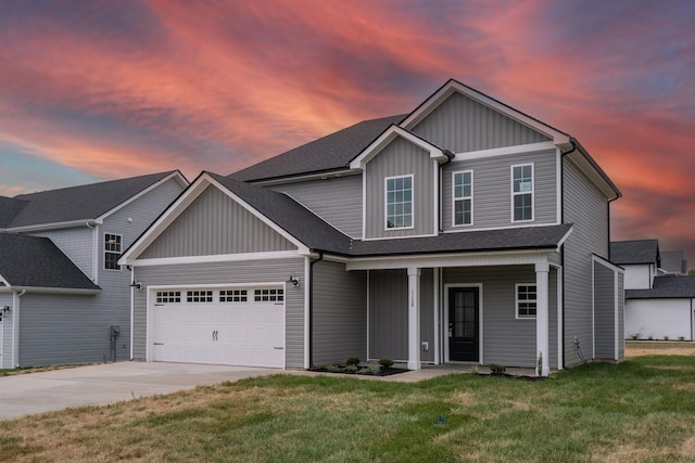 view of front of house featuring a lawn, a porch, and a garage