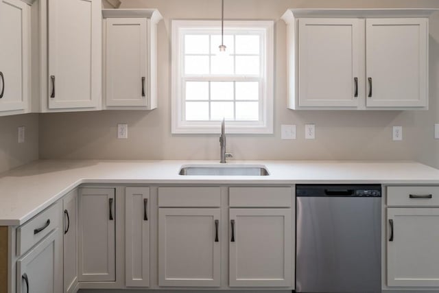 kitchen with white cabinets, dishwasher, sink, and hanging light fixtures