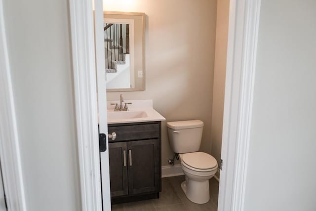 bathroom featuring tile patterned flooring, vanity, and toilet