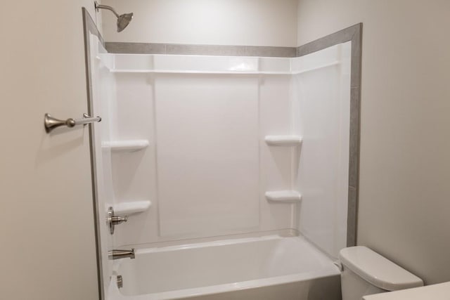 bathroom with toilet and washtub / shower combination