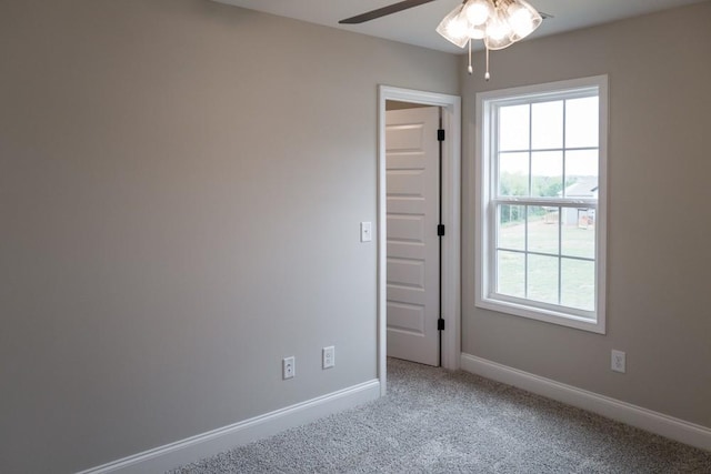 carpeted empty room featuring ceiling fan