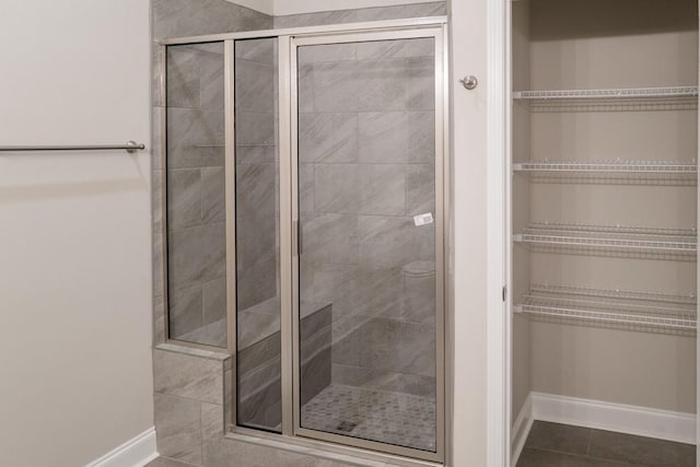 bathroom featuring tile patterned floors and a shower with door