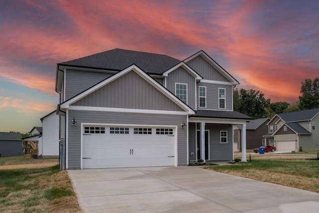 view of front of property featuring a yard and a garage