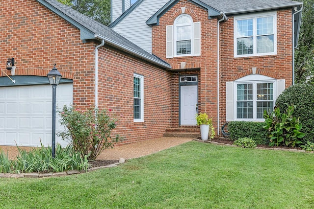 view of front of home with a garage and a front lawn