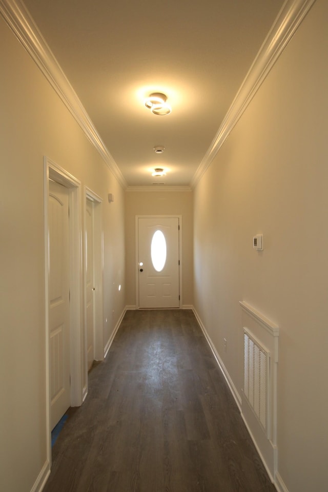 entryway with dark hardwood / wood-style flooring and crown molding