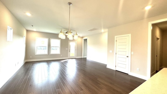 interior space with dark hardwood / wood-style floors and an inviting chandelier