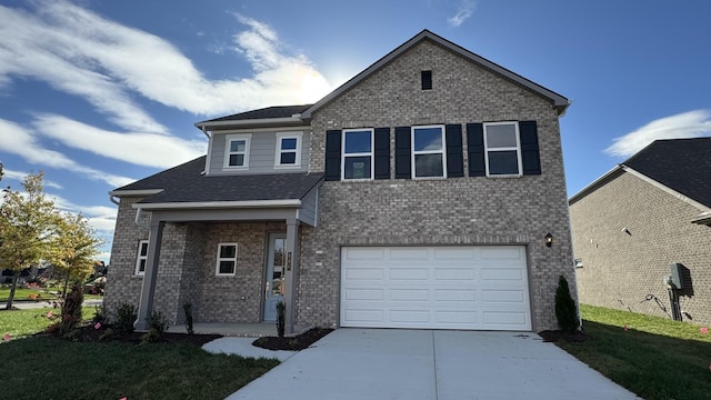 view of front of house featuring a front lawn and a garage