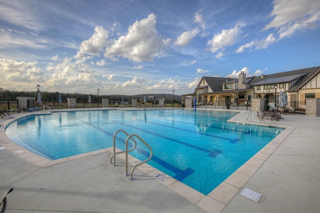 view of swimming pool with a patio