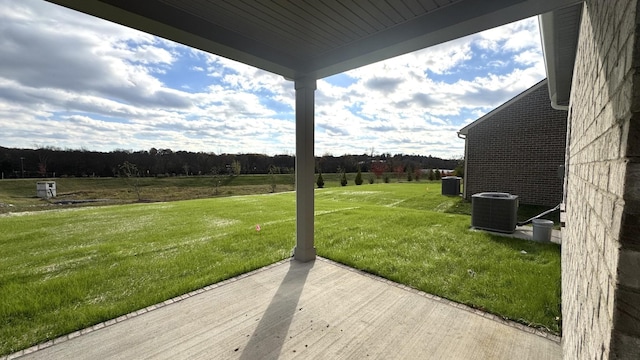 view of yard featuring a patio and central AC unit