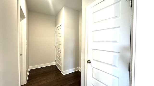 corridor with dark hardwood / wood-style floors