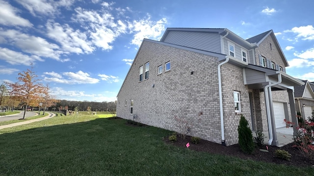 view of home's exterior with a garage and a lawn