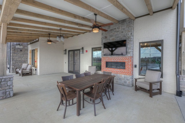 view of patio / terrace featuring ceiling fan and a fireplace