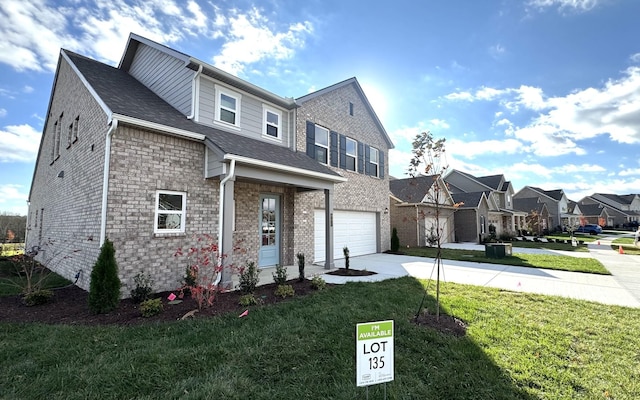 view of front of home with a garage and a front lawn