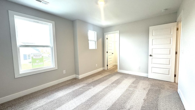 unfurnished bedroom with light colored carpet