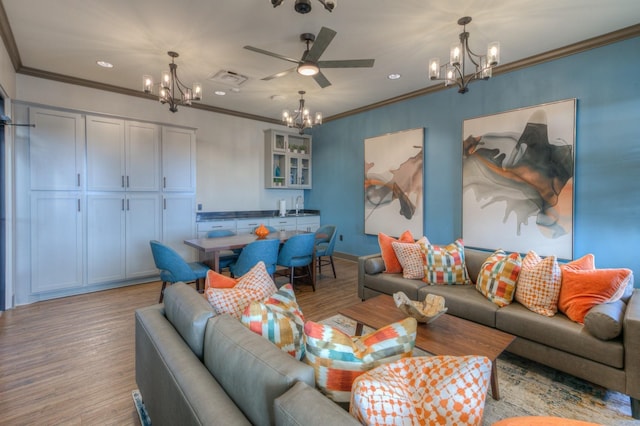 living room featuring ceiling fan, crown molding, sink, and light hardwood / wood-style flooring