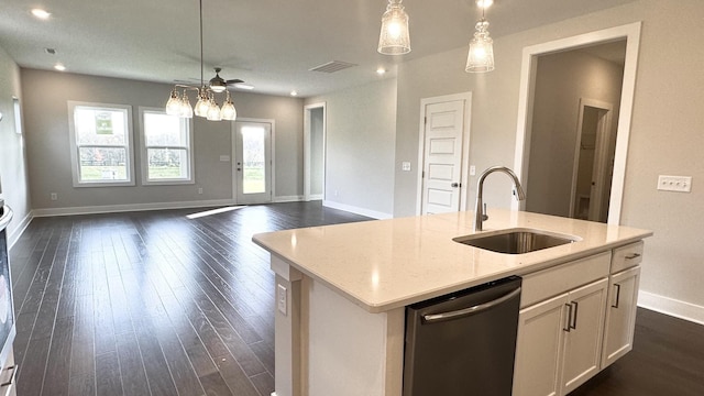 kitchen featuring dishwasher, pendant lighting, a center island with sink, and sink