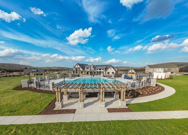 view of swimming pool with a lawn and a patio