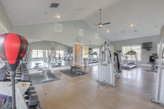 gym with ceiling fan, hardwood / wood-style floors, and high vaulted ceiling