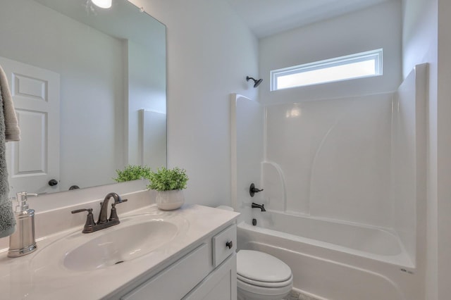 full bathroom with toilet, vanity, and washtub / shower combination