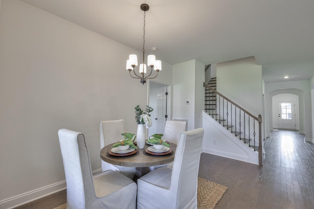 dining room featuring dark hardwood / wood-style flooring and a notable chandelier