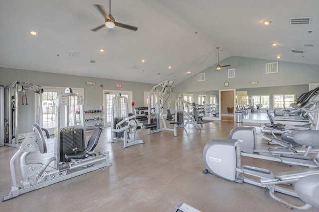 workout area featuring ceiling fan, light wood-type flooring, and vaulted ceiling