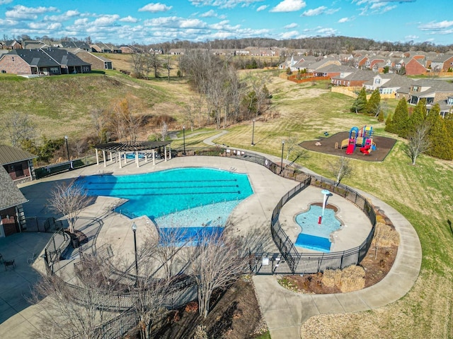 view of swimming pool with a patio and a playground