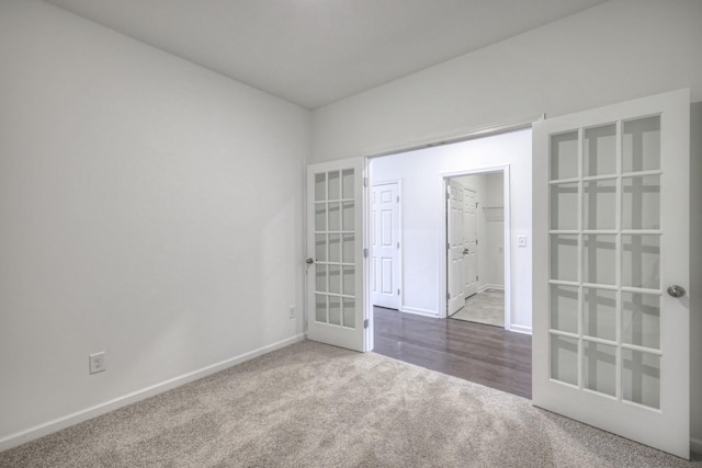 carpeted empty room featuring french doors