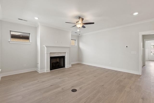 unfurnished living room with ornamental molding, ceiling fan, and light wood-type flooring