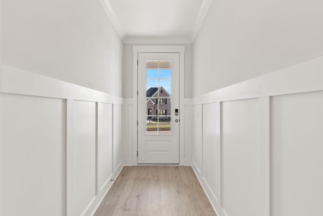 entryway featuring crown molding and light wood-type flooring