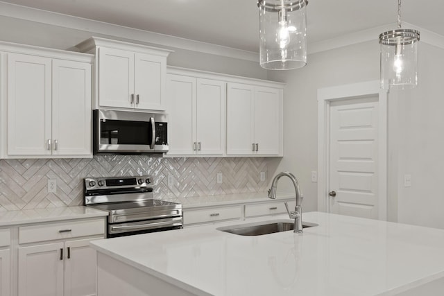 kitchen featuring stainless steel appliances, white cabinetry, sink, and backsplash