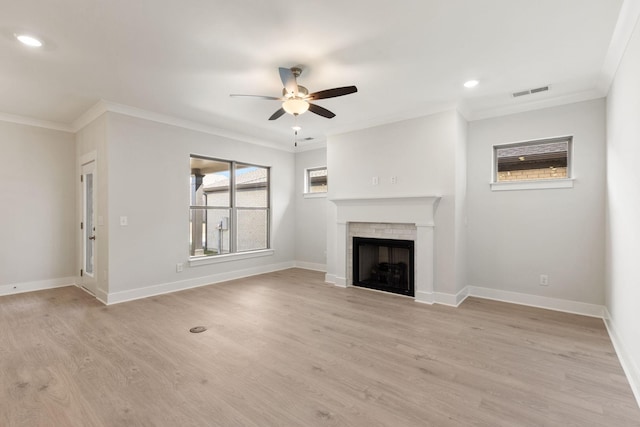 unfurnished living room with ceiling fan, ornamental molding, and light hardwood / wood-style flooring