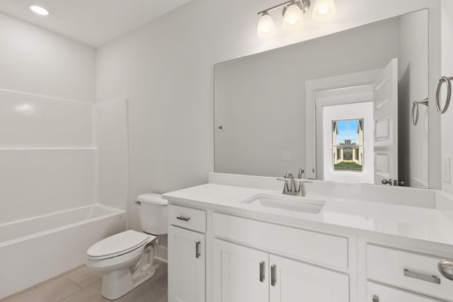 full bathroom with vanity, hardwood / wood-style floors, shower / bathtub combination, and toilet