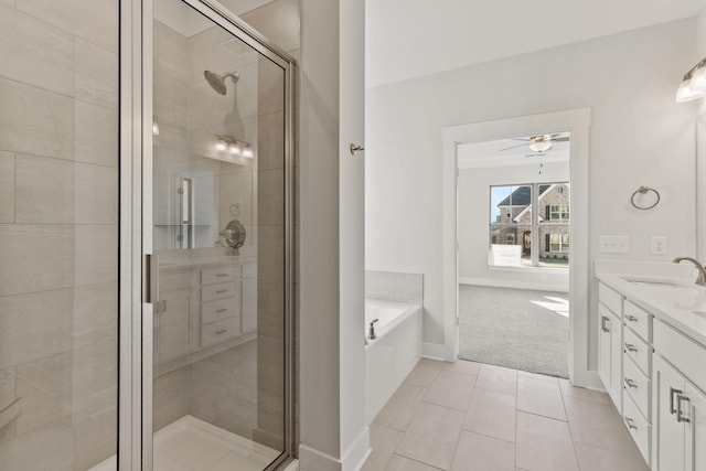 bathroom with vanity, tile patterned floors, shower with separate bathtub, and ceiling fan