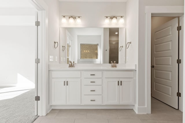 bathroom featuring tile patterned floors, vanity, and a shower with door