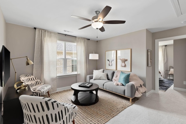 carpeted living room with ceiling fan