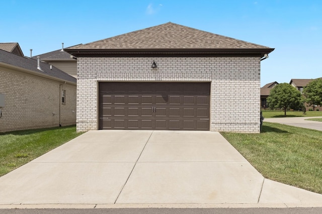 exterior space with a garage and a lawn