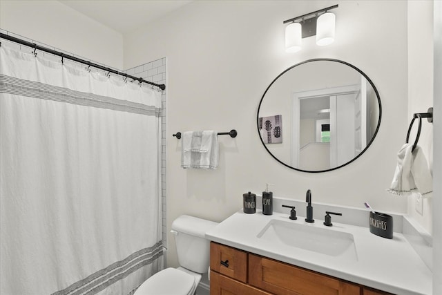 bathroom with toilet, vanity, and a shower with shower curtain