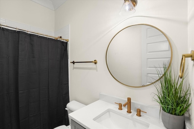 bathroom with toilet, vanity, and a shower with shower curtain